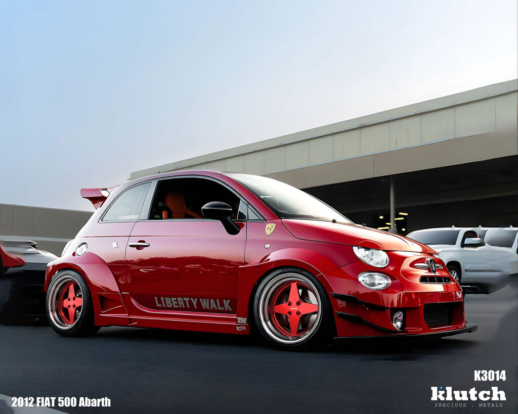 2012 FIAT 500 Abarth Liberty Walk widebody on Klutch K3014 3-piece forged wheels – aggressive stance front angle with deep lip and red modular spokes
