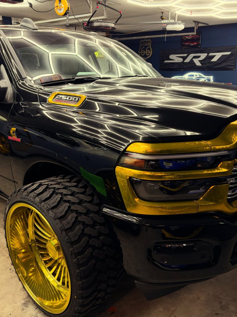 Close-up of gold Klutch forged wheel on a custom RAM heavy-duty truck