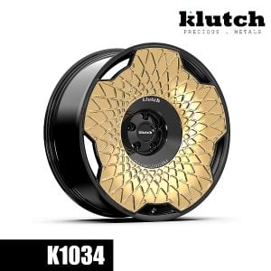 Three-quarter view of the Klutch K1034 forged wheel with a gold geometric face and black center and barrel