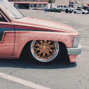 Close-up of a copper-toned Klutch K3020 wheel with polished outer lip on a pink Toyota pickup